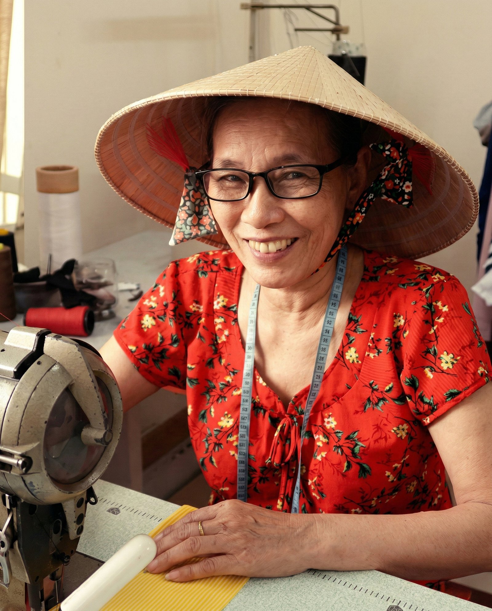 A smiling DINS artisan at her work table